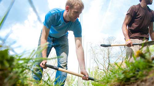 Man digging in soil. 